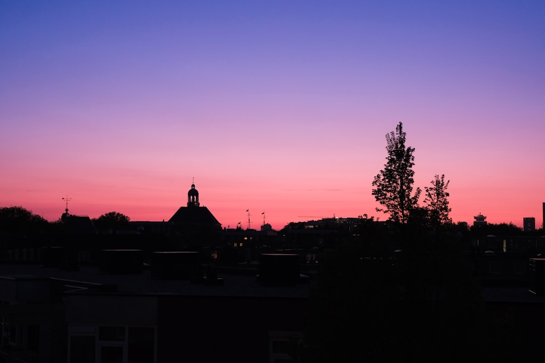 Colorful sunset sky over city silhouette