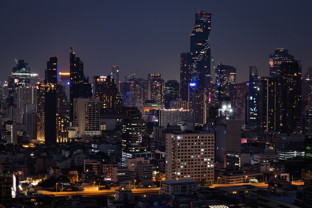 a city at night with a lot of tall buildings