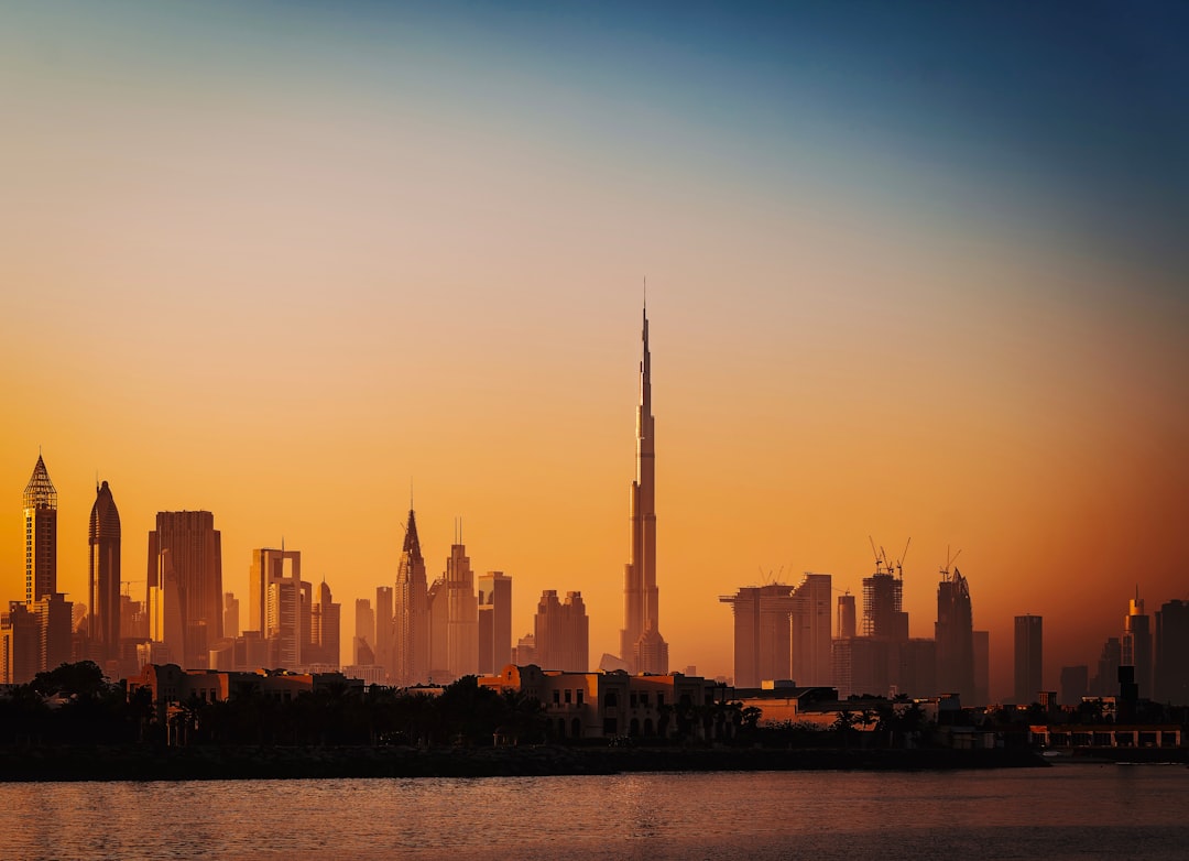 city skyline during sunset with body of water