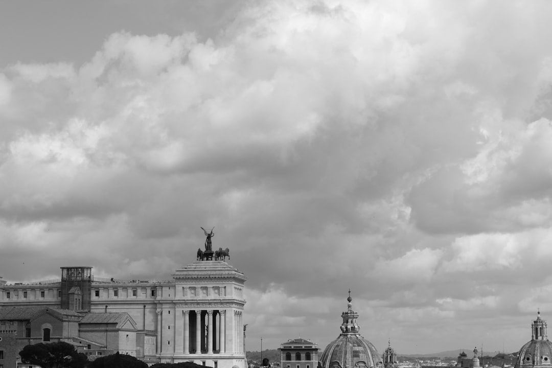 Clouds loom over a classical italian cityscape.
