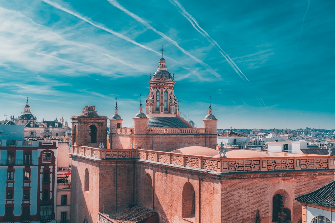 Historic european building with a domed tower under blue sky.