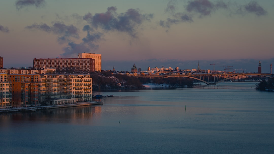 a view of a city and a river at sunset