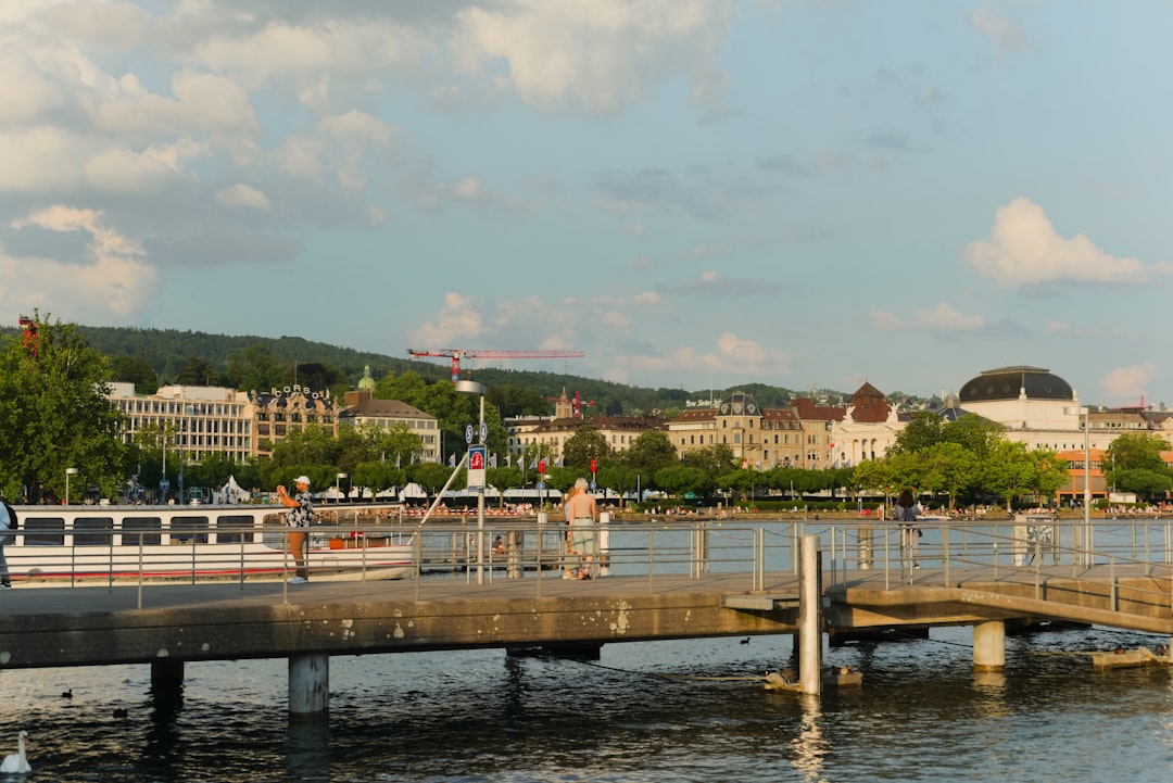 Boats on a lake with city buildings in background