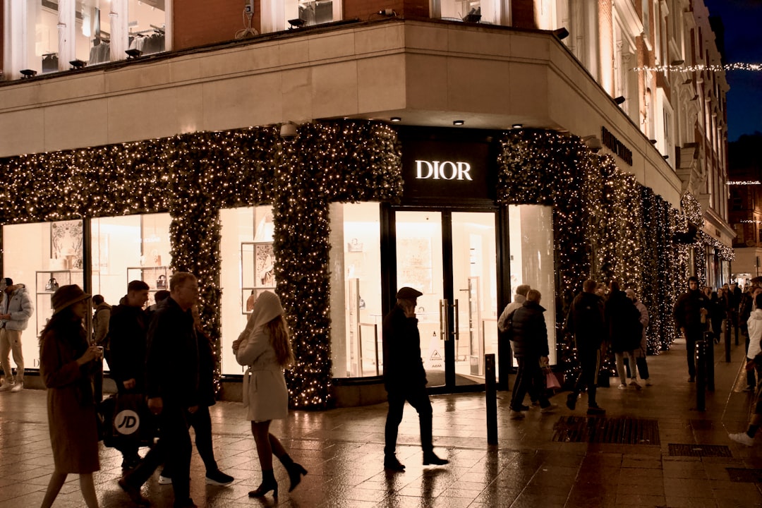 A dior storefront is illuminated at night.